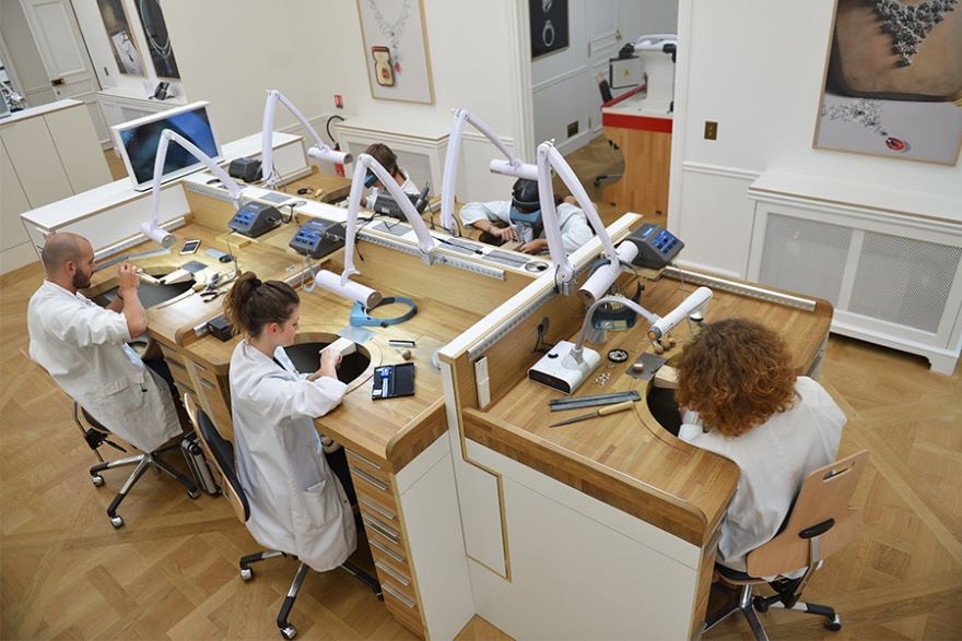 Watchmakers working on different watches in the workshop