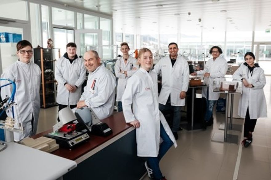 A group photo of the team of watchmakers in the workshop