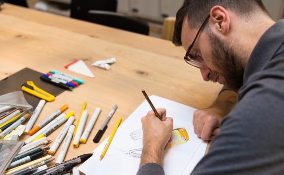 A designer creating sketches with new watch designs