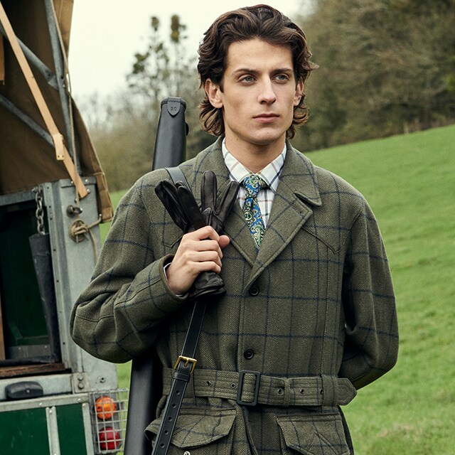 Man wearing a green coat going om a hunt